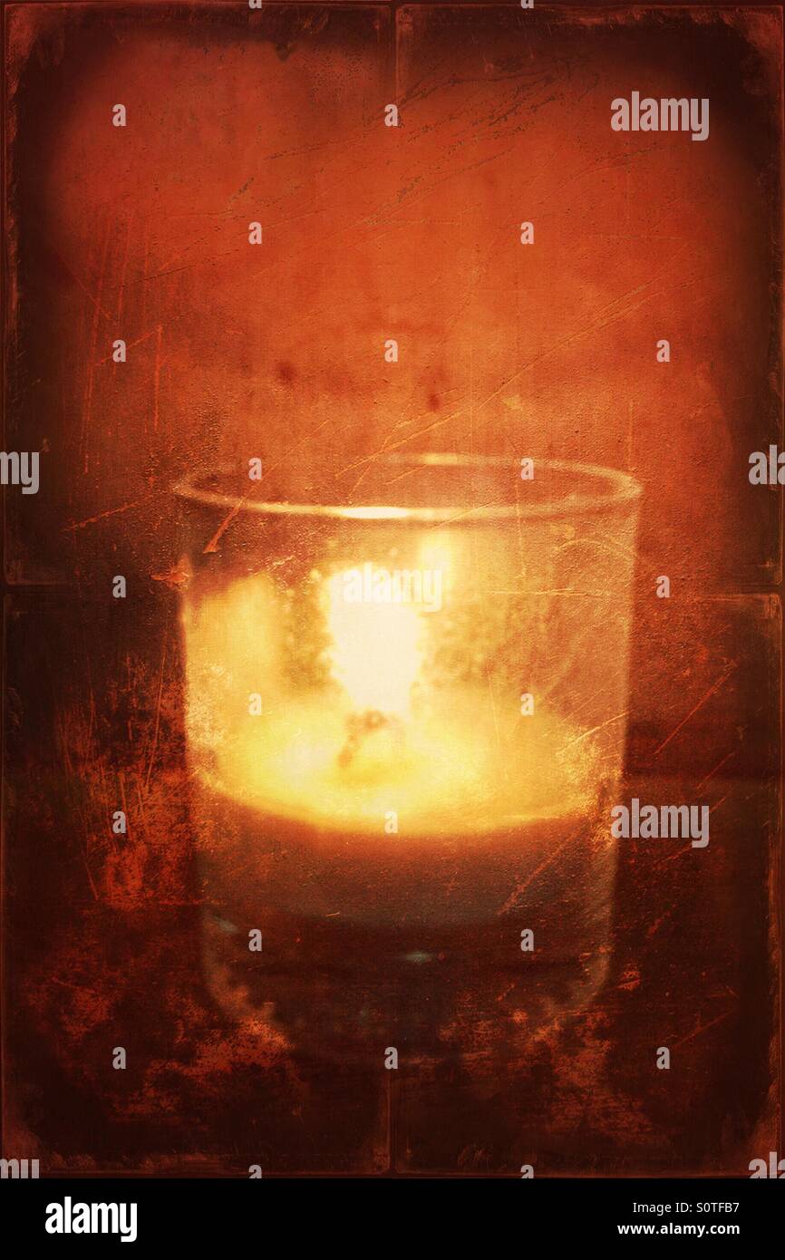 Lit candle in a glass Stock Photo Alamy