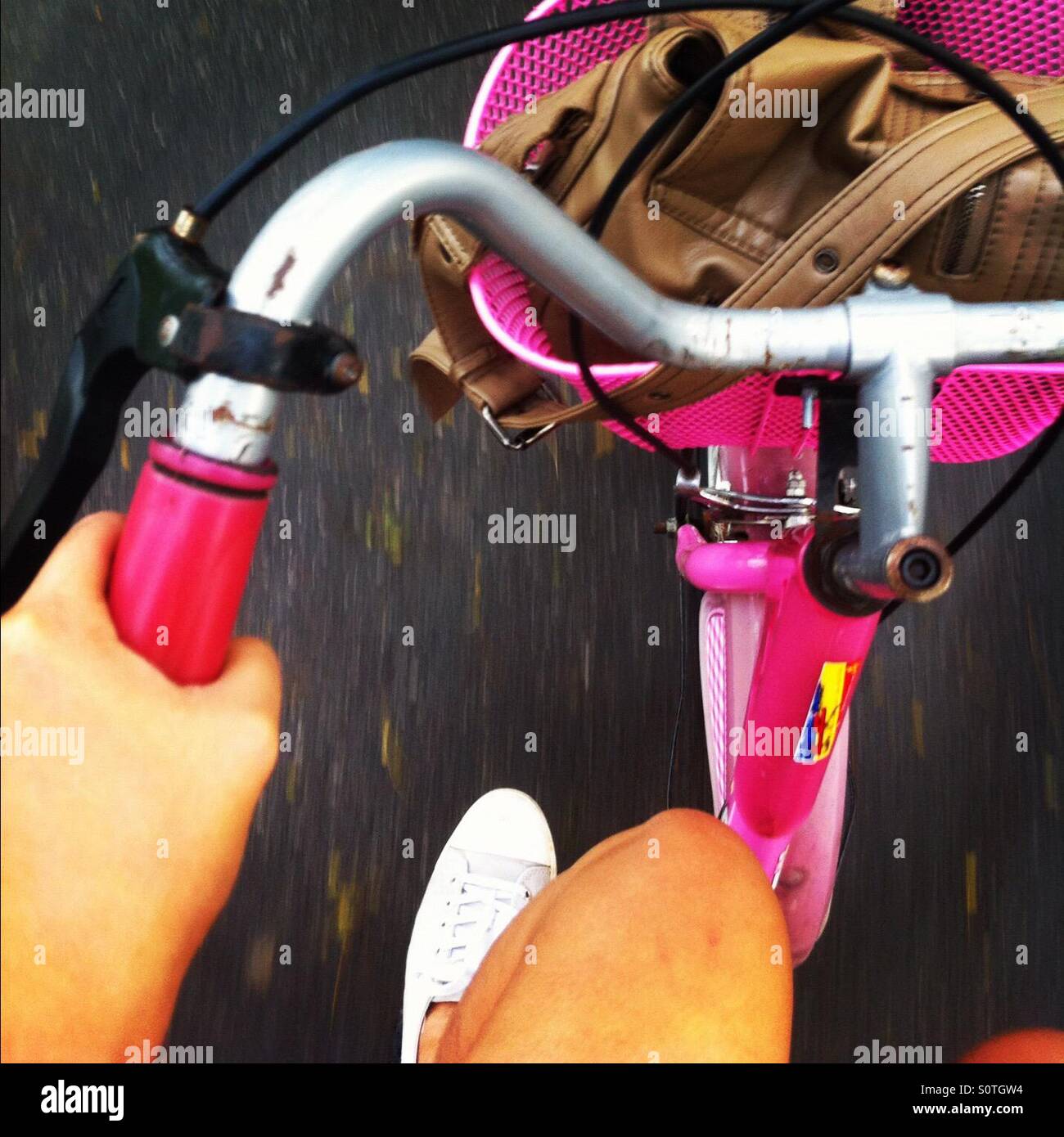 Riding a pink bicycle Stock Photo