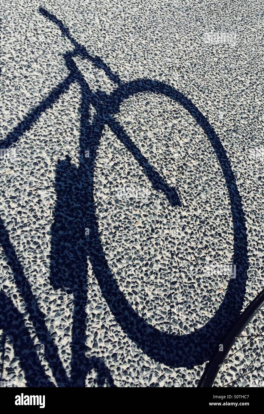 Silhouette of bicycle on road Stock Photo