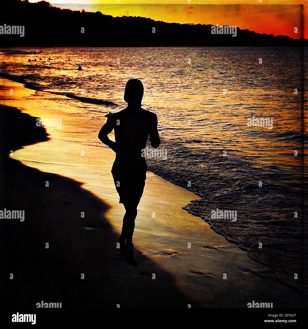 Jogger on beach Stock Photo