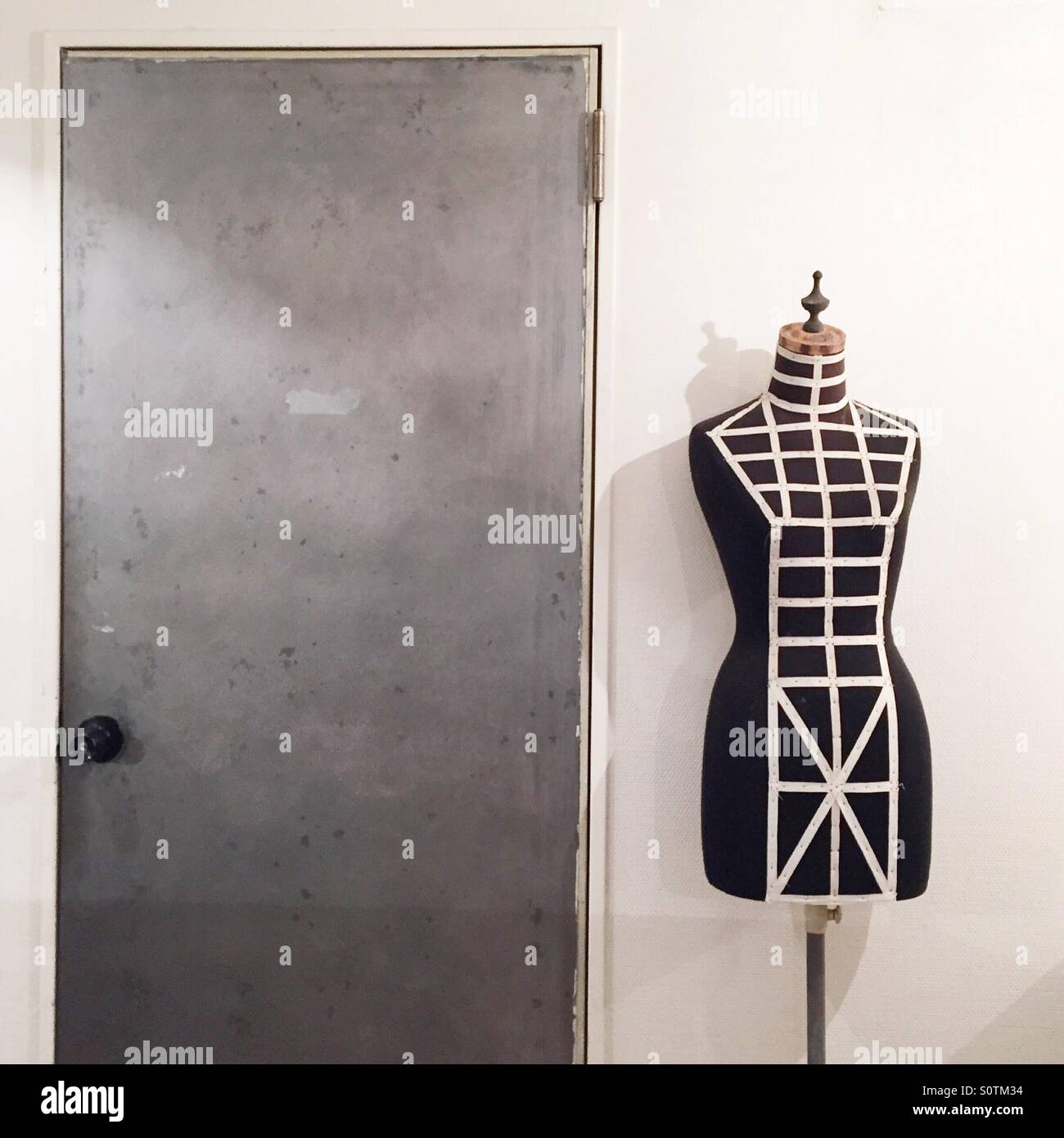 vintage mannequin standing in front of doorway Stock Photo