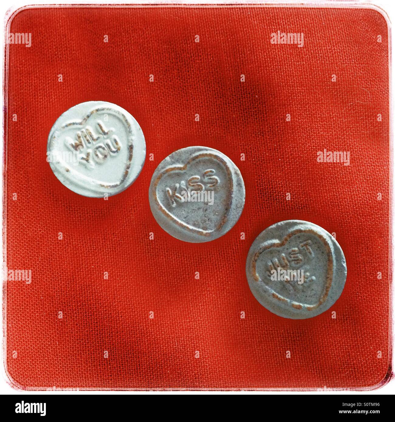 'Will you kiss just me' message . Loveheart sweets. - Smartphone Captured Stock Image