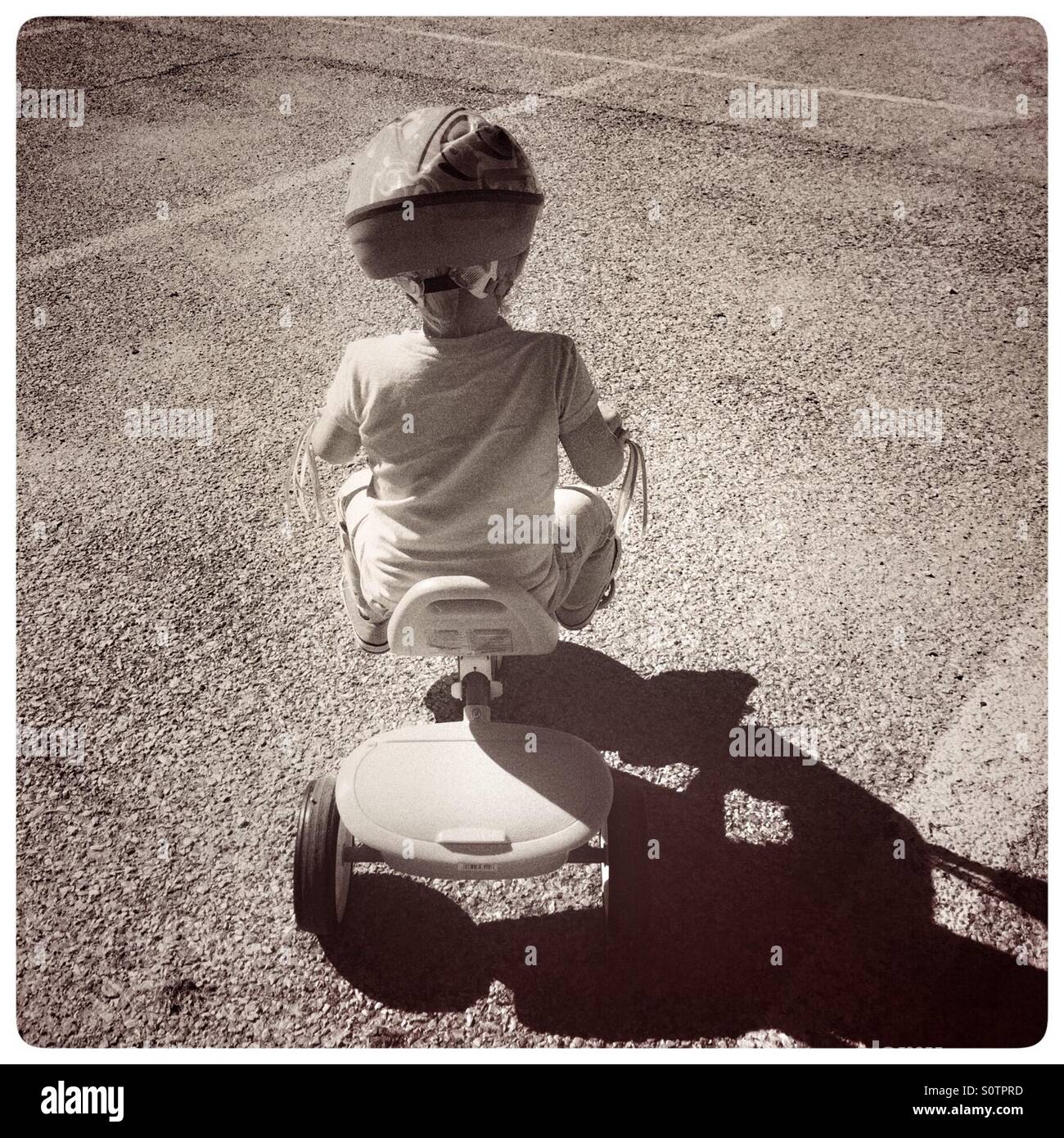 girl riding tricycle