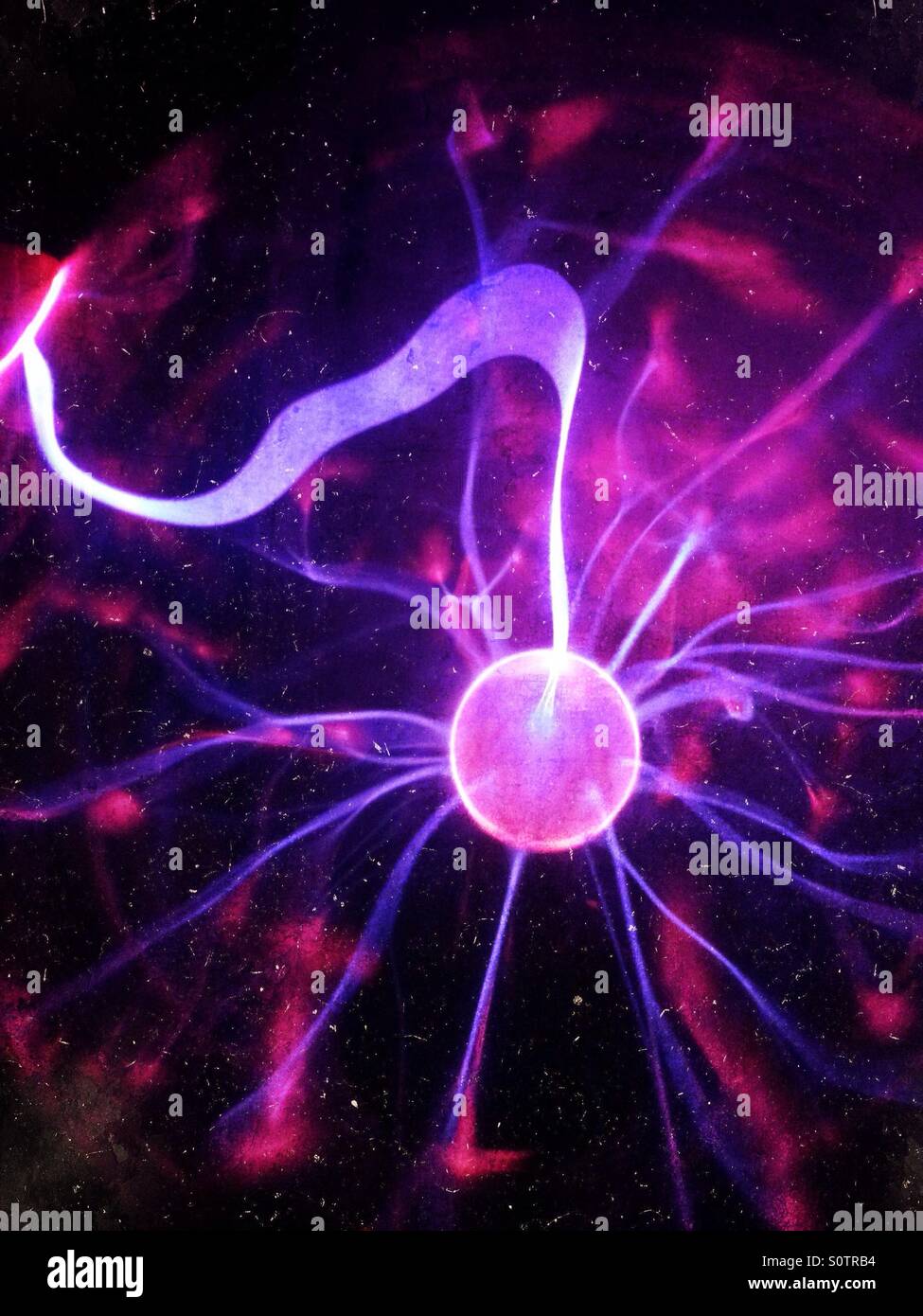 Plasma ball with silhouette of persons finger touching it - Smartphone Captured Stock Image