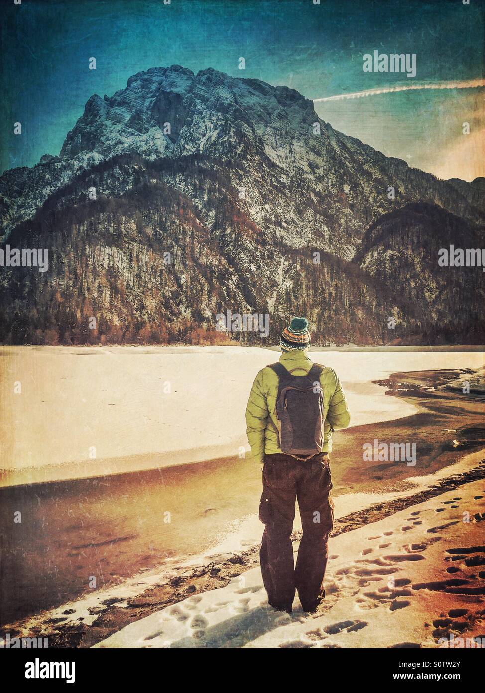 Hiker with a backpack standing in front of snow covered mountain - Cima del Lago, Italy - Smartphone Captured Stock Image
