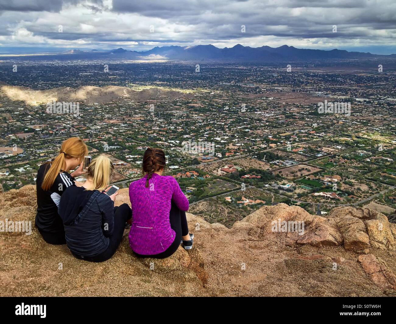 Three female hikers on Mountain summit, Camelback Mountain, Phoenix, Arizona, USA Stock Photo