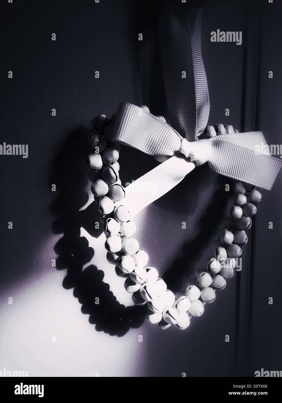 Decorative heart shaped garland casting shadow - Smartphone Captured Stock Image