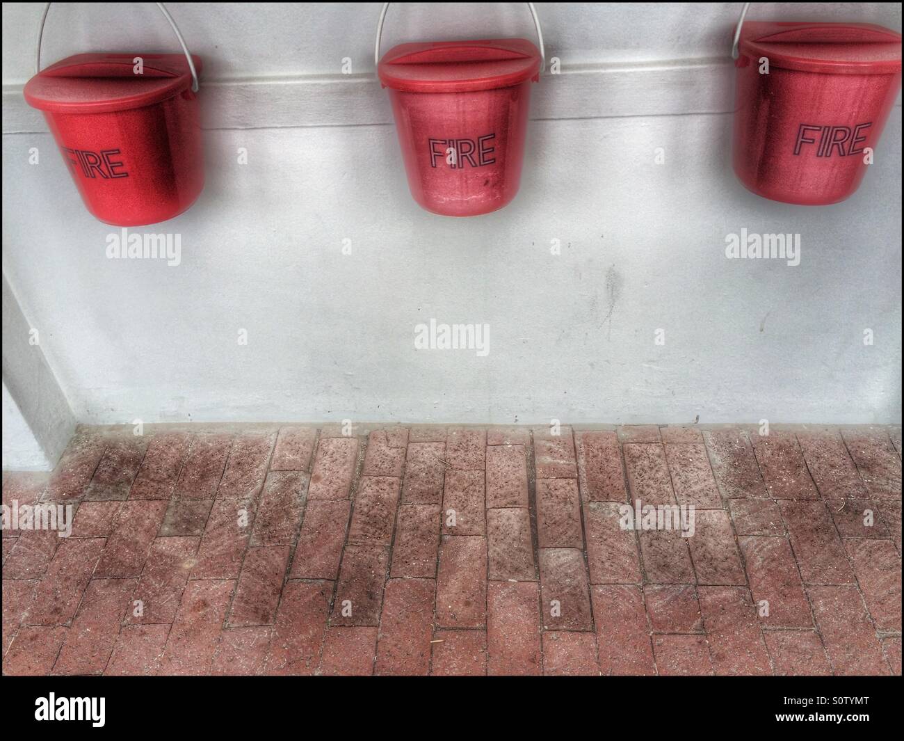 Fire prevention buckets mounted on wall. - Smartphone Captured Stock Image