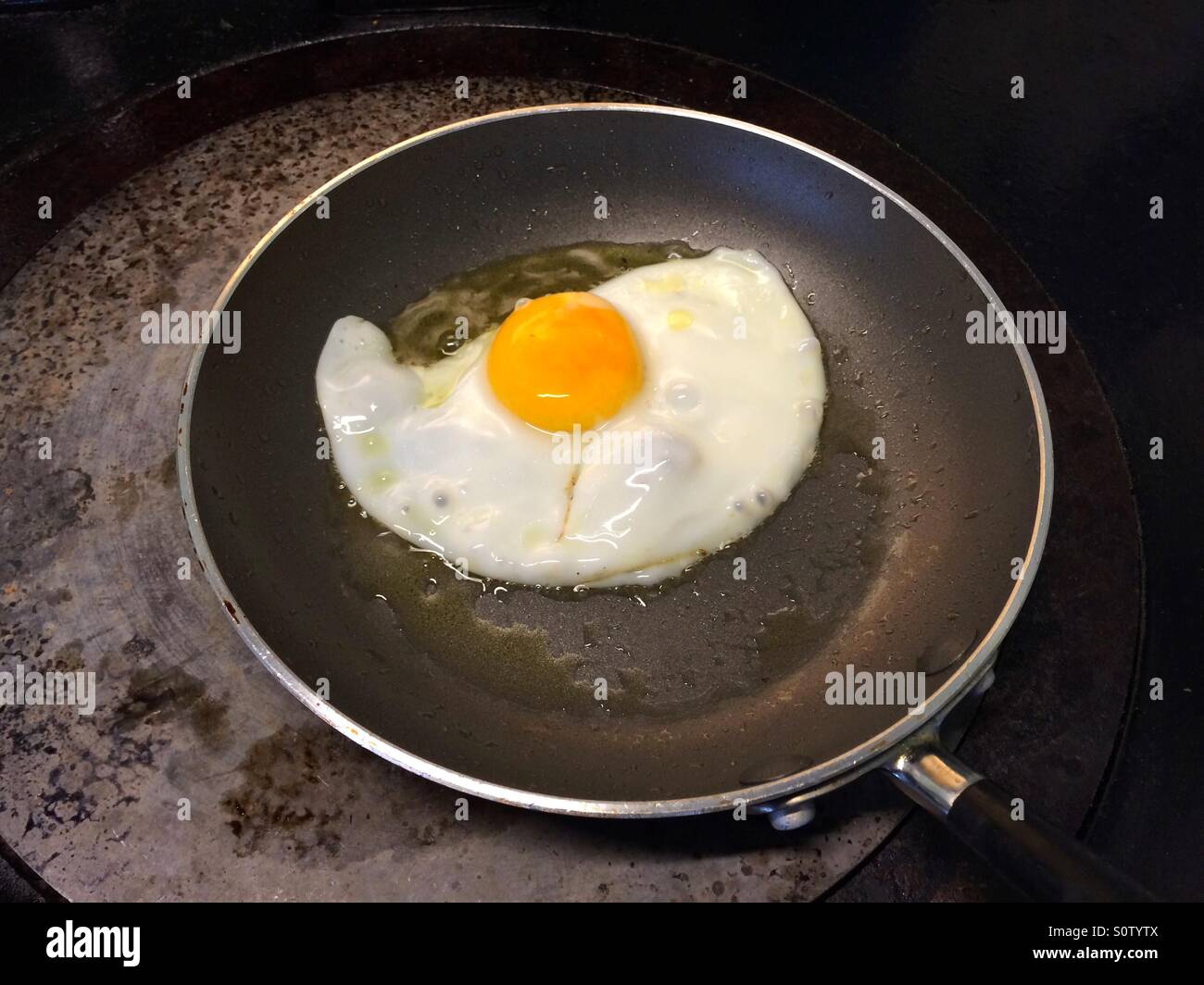 Frying an egg Stock Photo Alamy
