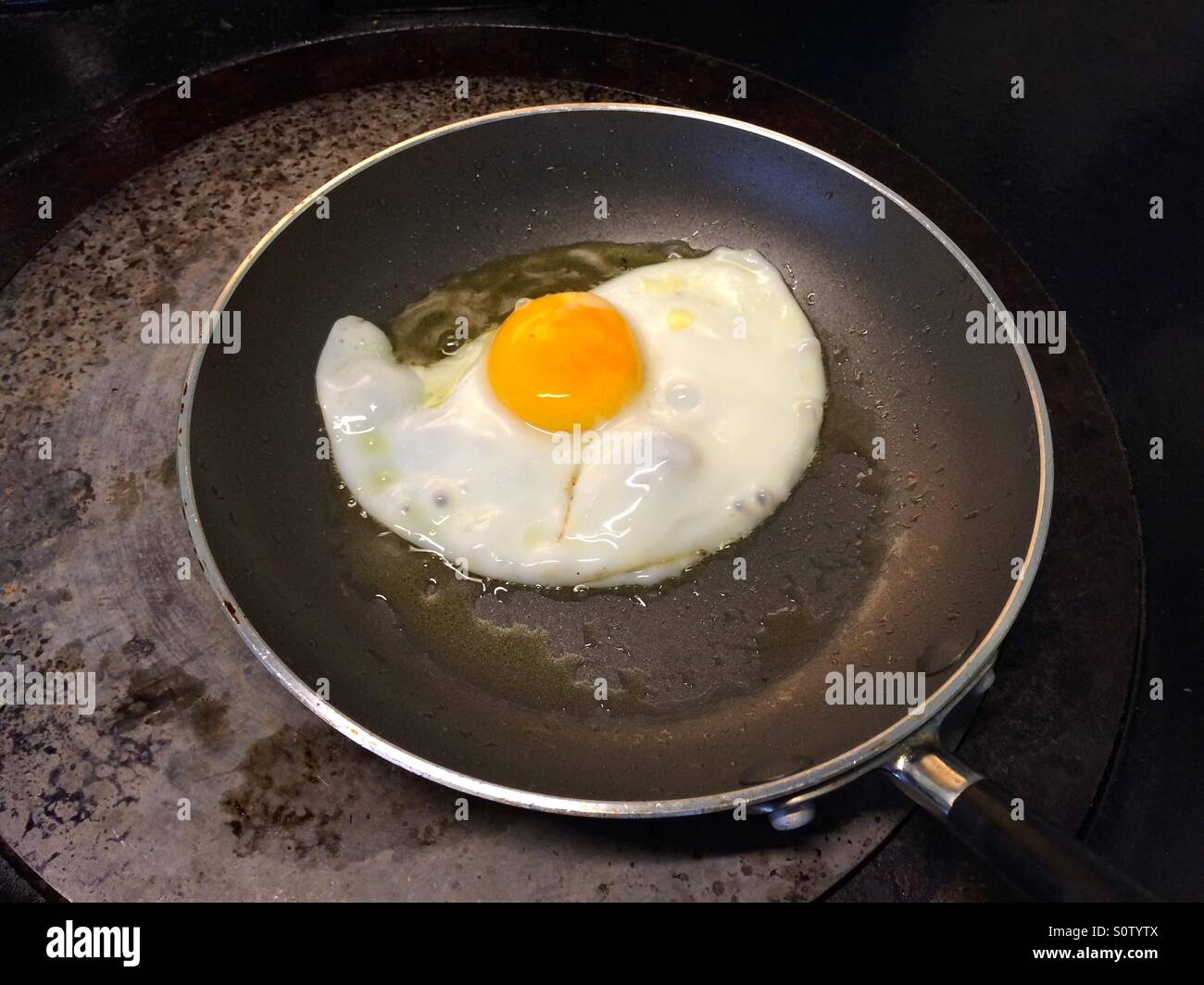 Frying an egg Stock Photo