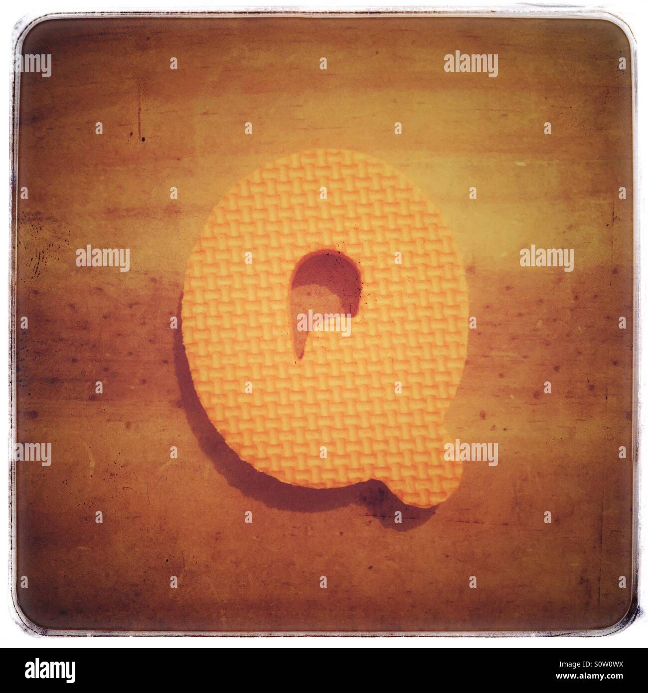 Textured foam letter Q on a grungy wood background Stock Photo