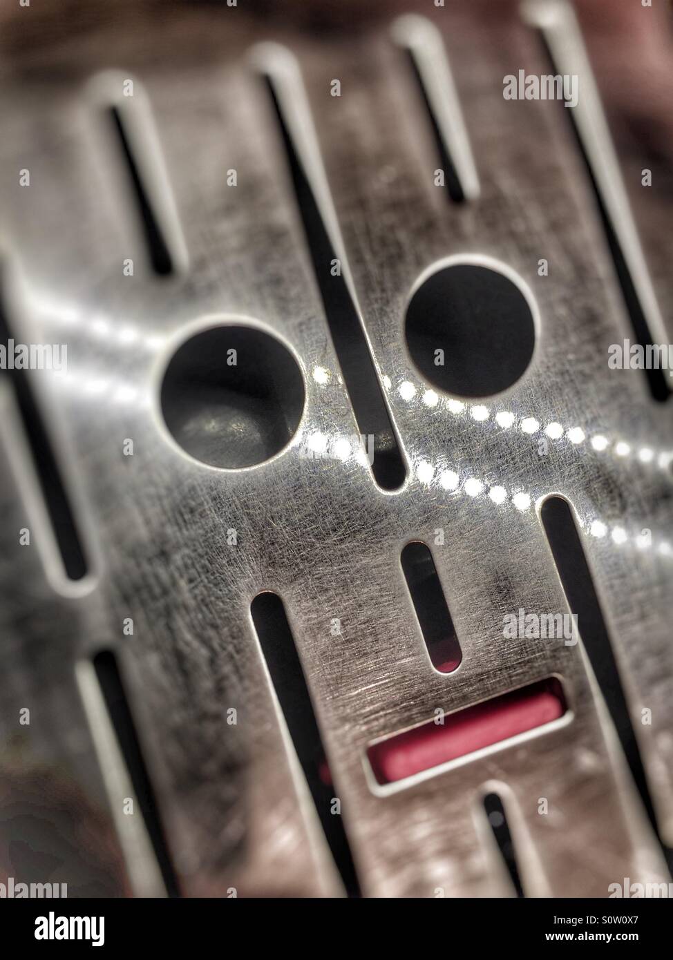 Abstract face in a coffee machine grill Stock Photo