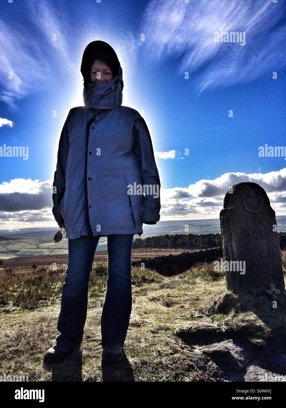 Woman stood by a RAF aircraft crash memorial on Ilkley Moor Stock Photo