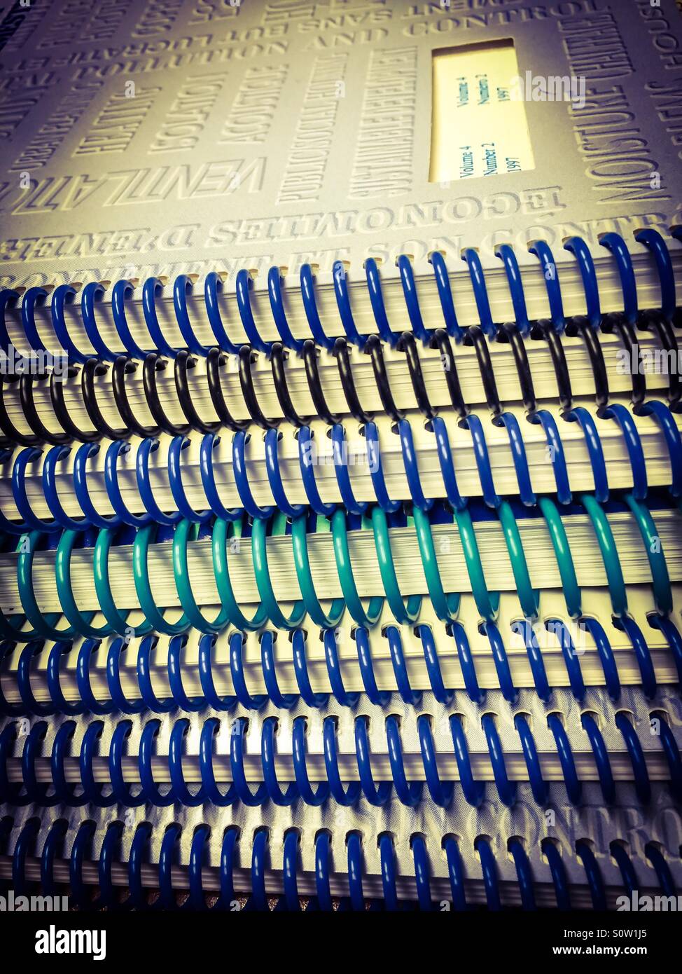 Stack of reports. Before paperless. Before IT. Many. Volumes. Parts. Colours. Colorful. - Smartphone Captured Stock Image