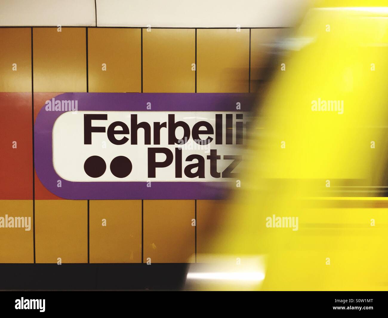 Fehrbelliner Platz U-Bahn subway station in Berlin with yellow train arriving at the platform, Germany. - Smartphone Captured Stock Image