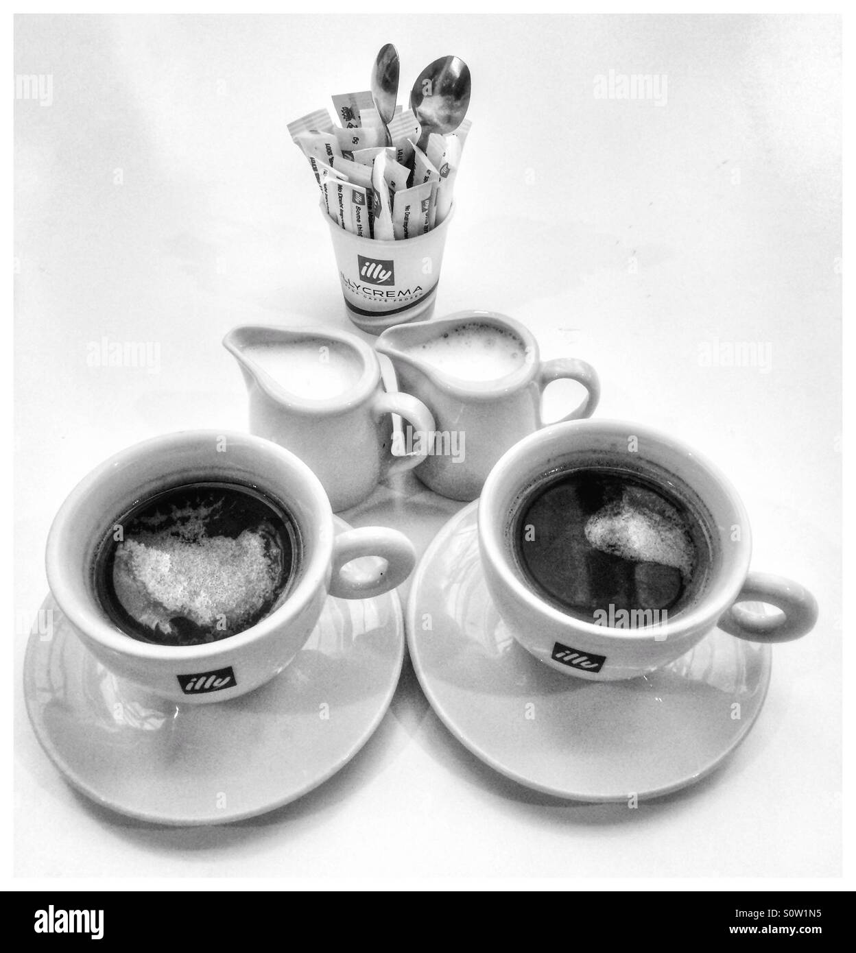 two cups of coffee, black and with milk, coffee grinder, cookies and coffee  beans Stock Photo - Alamy