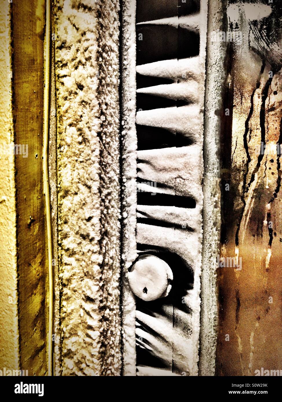 Frozen thick icy frost on door and doorknob INSIDE a Montréal restaurant in -23°C weather. - Smartphone Captured Stock Image