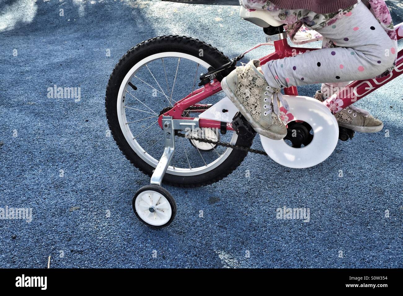 Girl learning to ride a bike Stock Photo