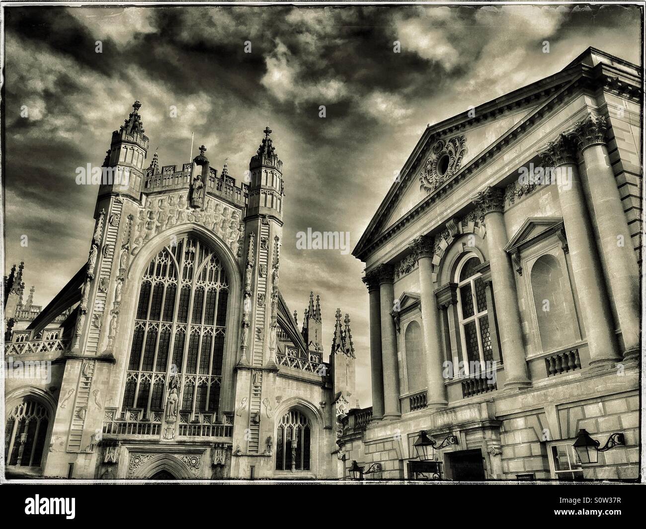 A view of the World Famous City of Bath in Somerset, England. Bath Abbey with the Angels ascending 'Jacobs Ladder.' On the right is the Roman Baths Pump Rooms. Photo Credit © COLIN HOSKINS. - Smartphone Captured Stock Image