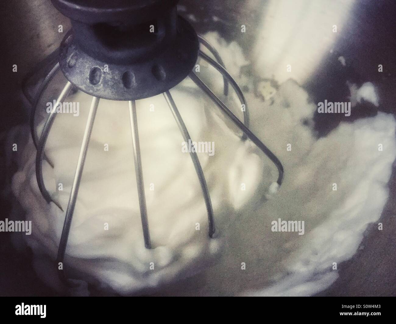 Egg whites being beaten up in an electric mixer. - Smartphone Captured Stock Image