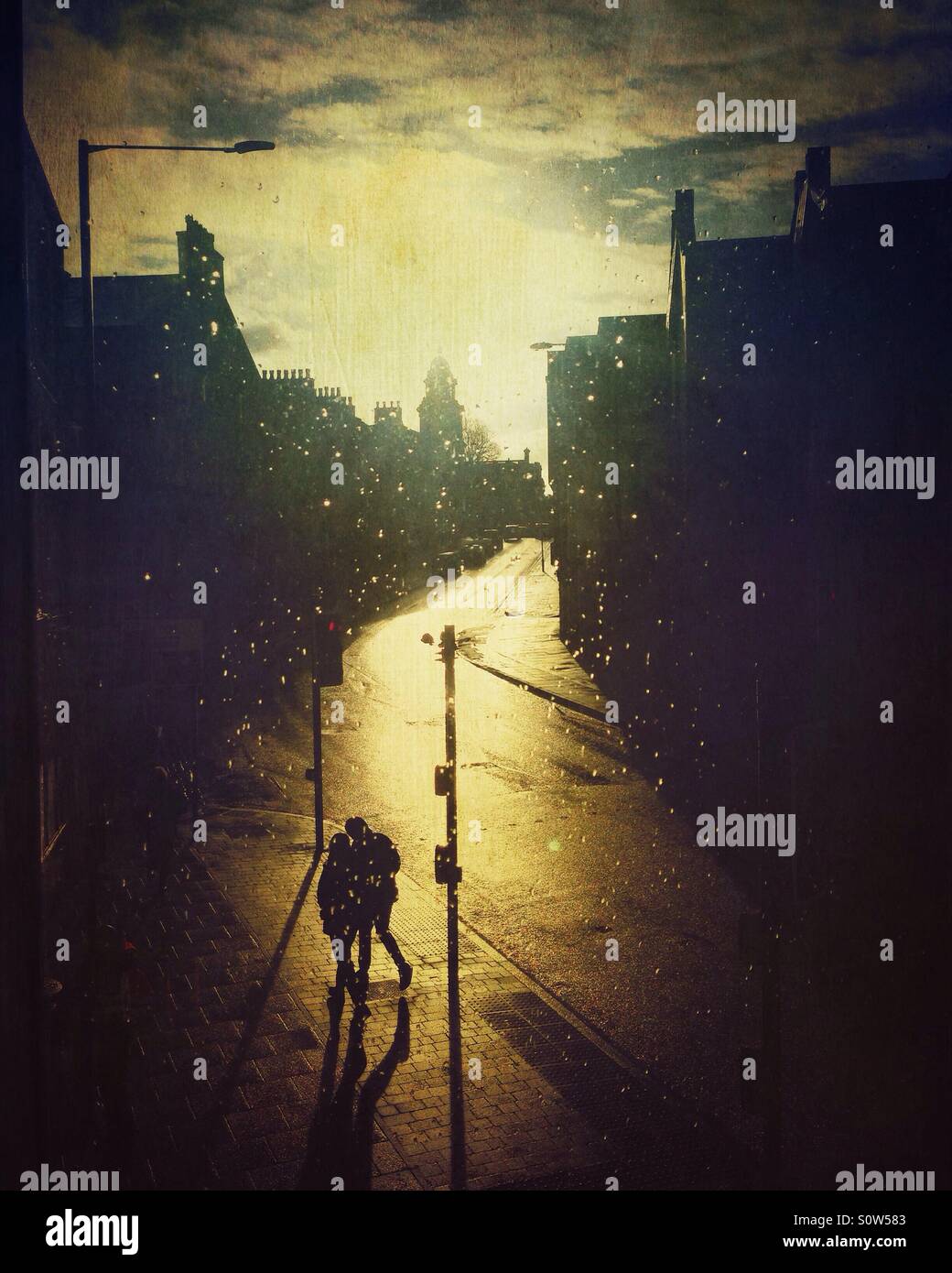 Couple walking at sunset in an empty city Stock Photo - Alamy