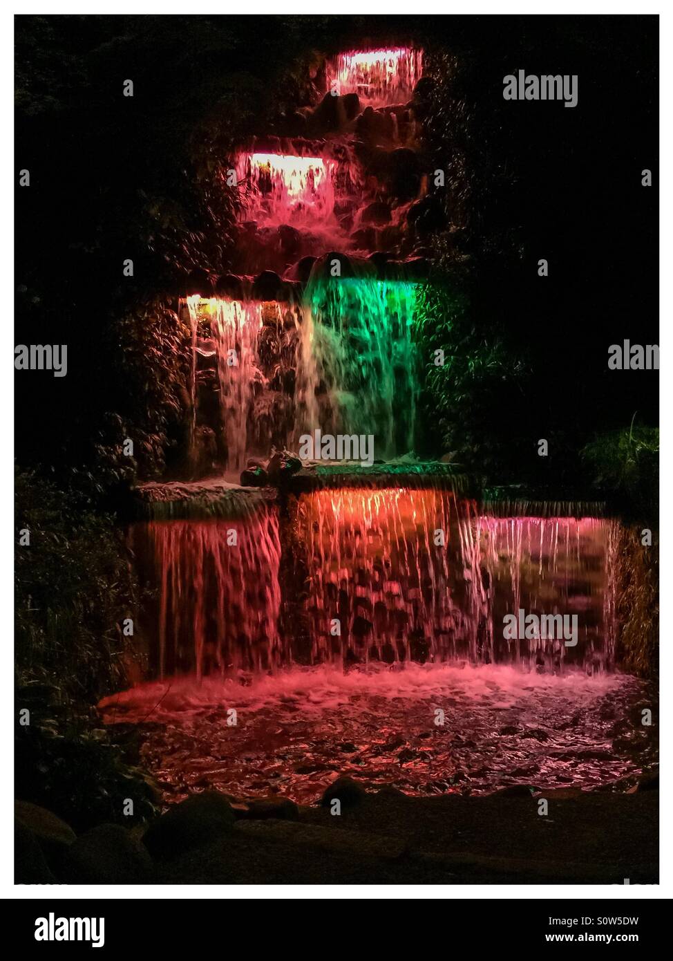 Multicoloured water in fountain at night Stock Photo - Alamy