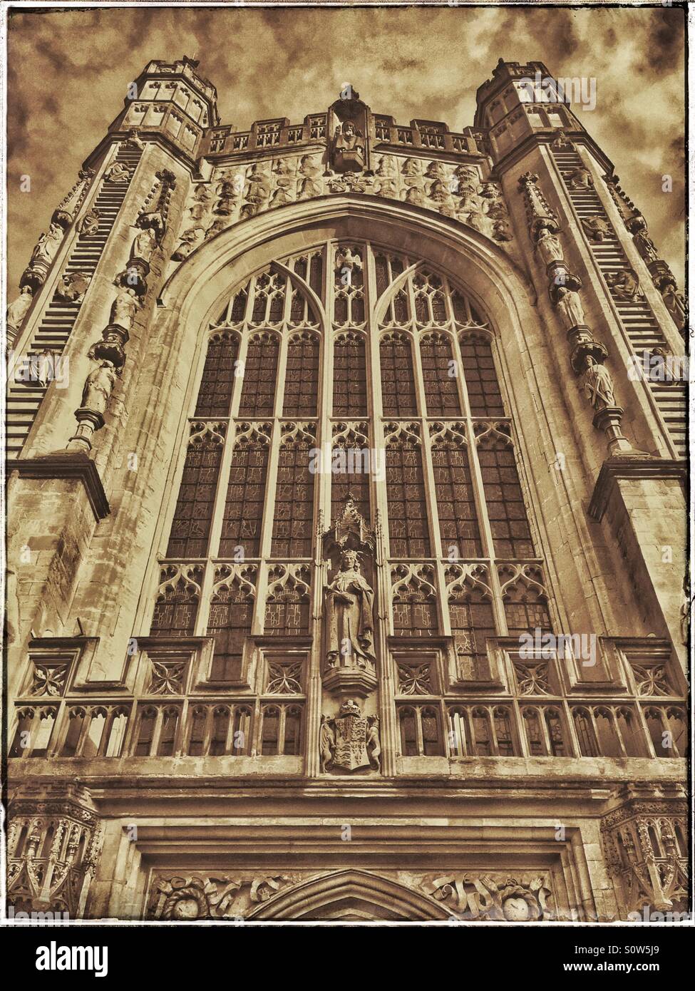 A view looking skyward of the West Front of Bath Abbey. Of interest are the 2 Ladders of Angels descending and ascending. Photo Credit - © COLIN HOSKINS. - Smartphone Captured Stock Image