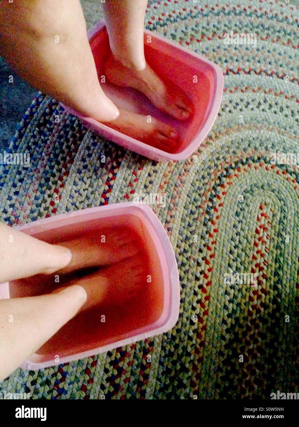 Two friends enjoying foot soaks Stock Photo Alamy