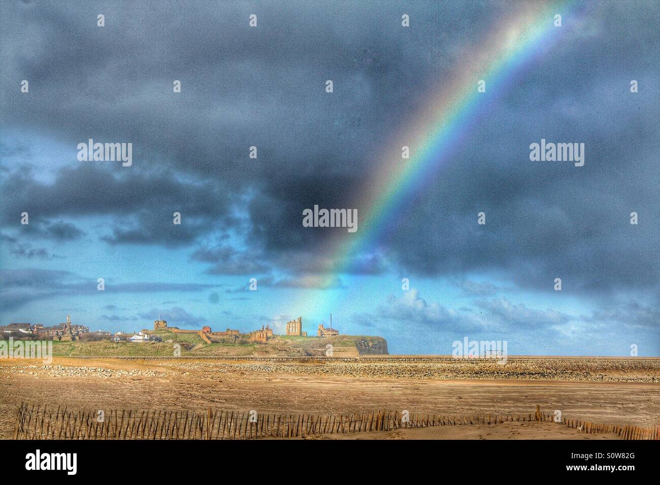 Rainbow over Tynemouth priory Stock Photo