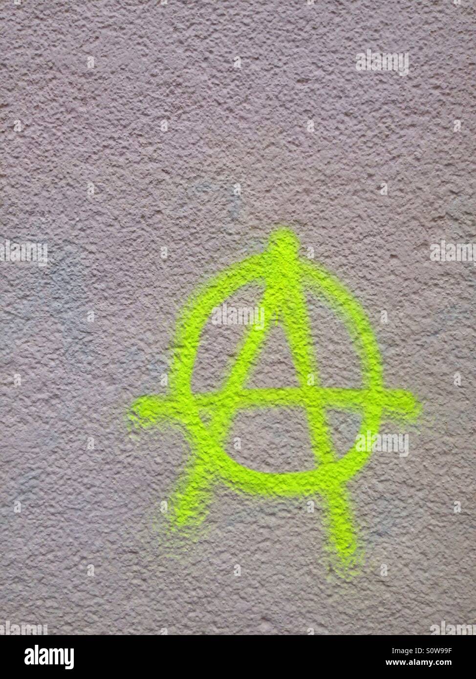 Bright yellow A for anarchy symbol on a wall - Smartphone Captured Stock Image