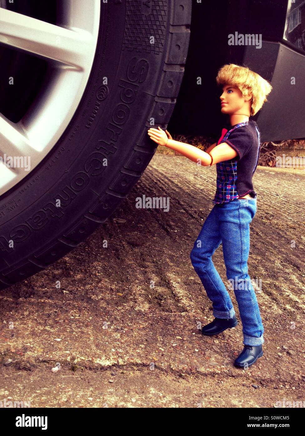 Ken pushing car wheel - Smartphone Captured Stock Image