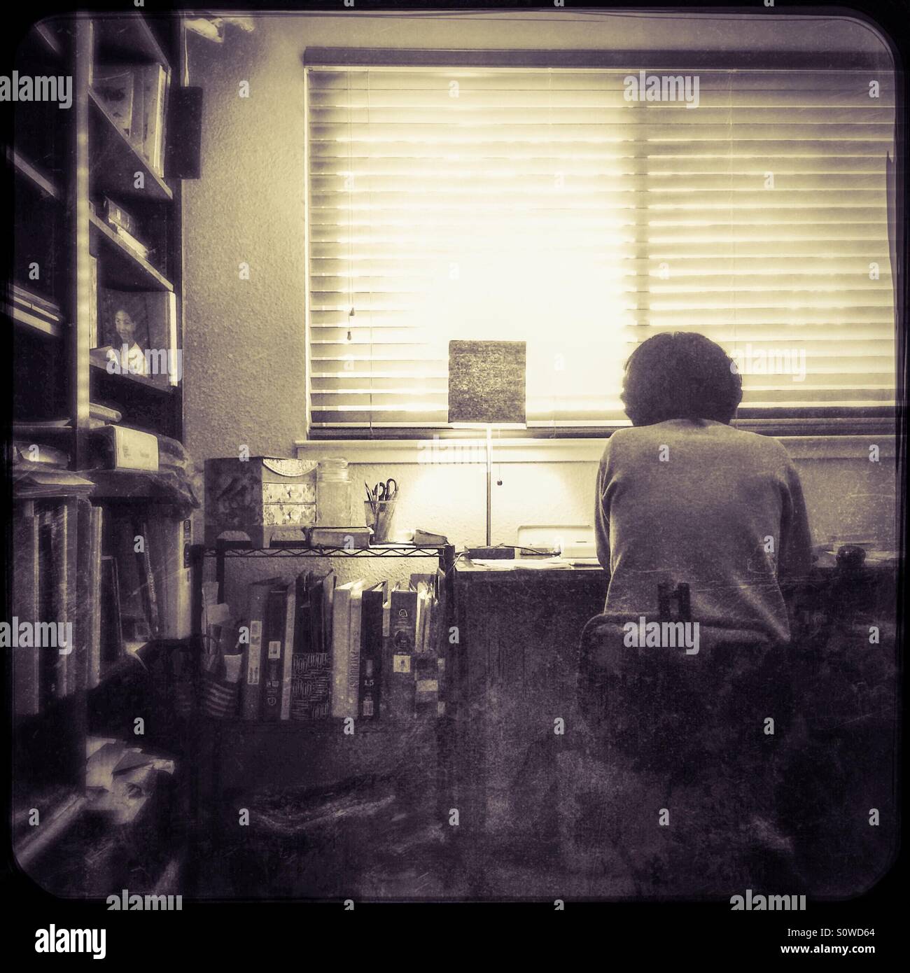 An Asian woman works from home in her office. - Smartphone Captured Stock Image