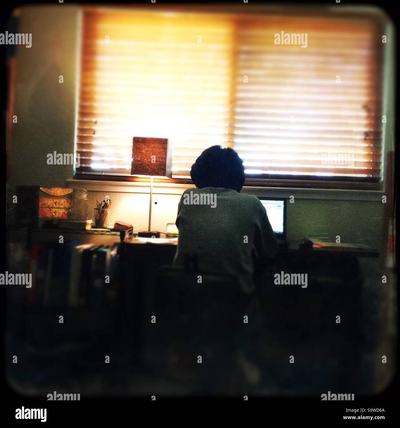 An Asian woman works from home in her office. - Smartphone Captured Stock Image