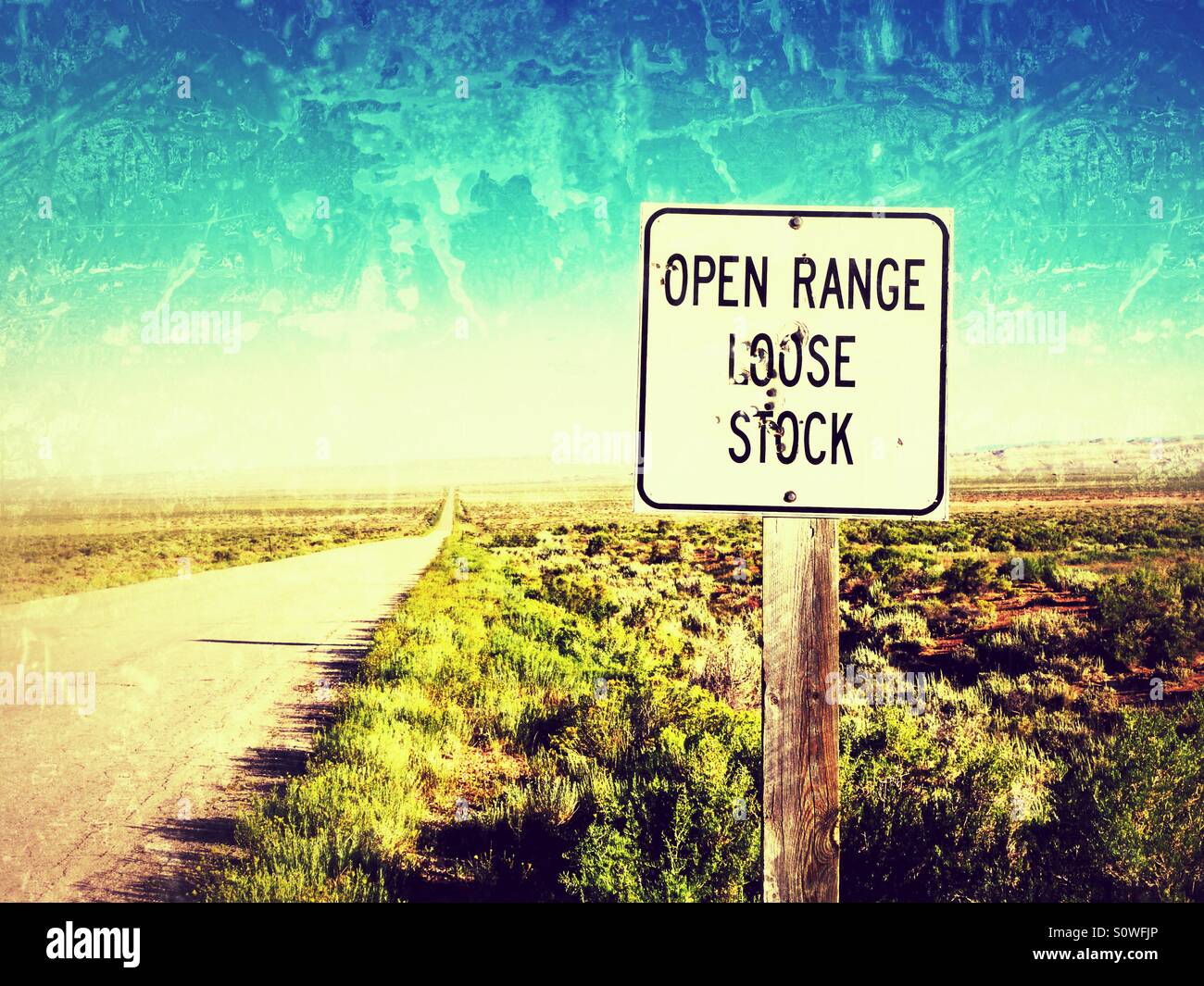 Open range sign along lonely road in Wyoming with bullet holes. Stock Photo