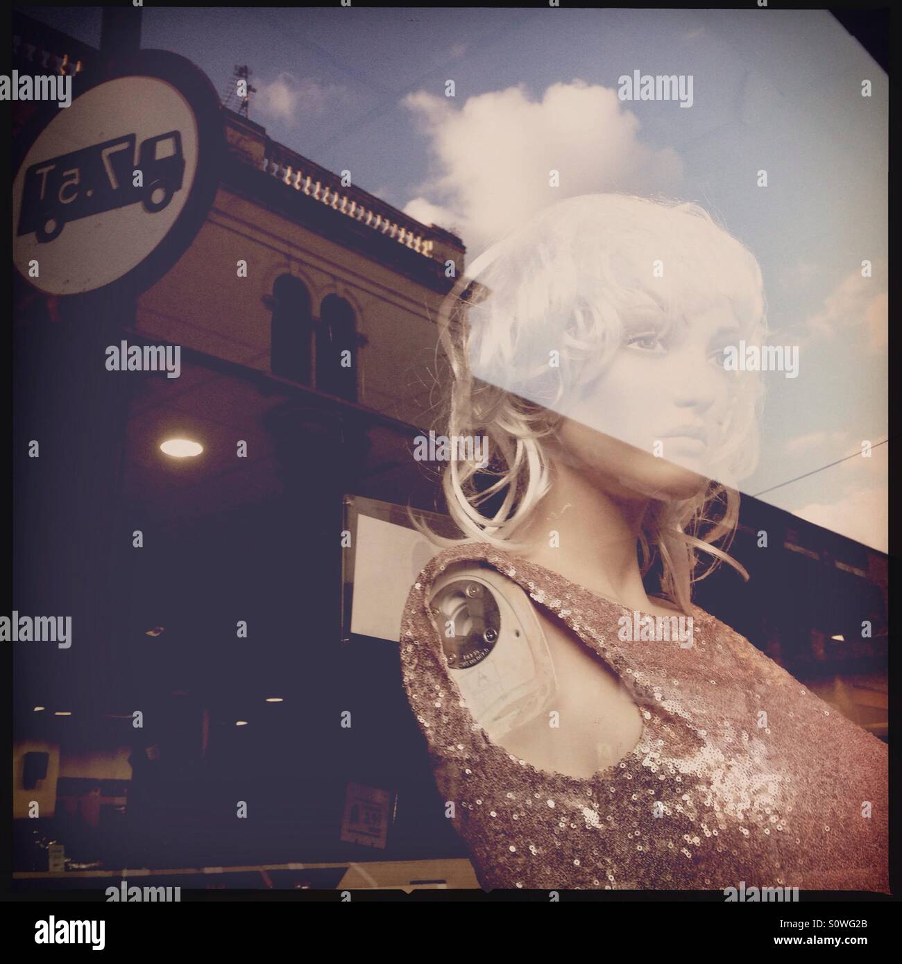 Mannequin and reflections on window display - Smartphone Captured Stock Image