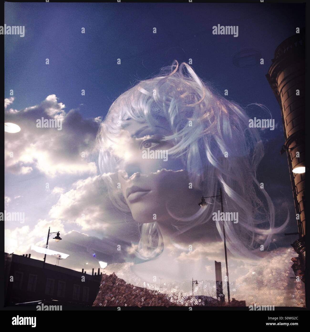 Fashion dummy mannequin and reflections on a window display in London UK - Smartphone Captured Stock Image