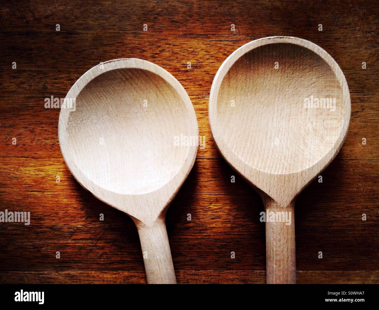 Two wooden spoons on a table - Smartphone Captured Stock Image