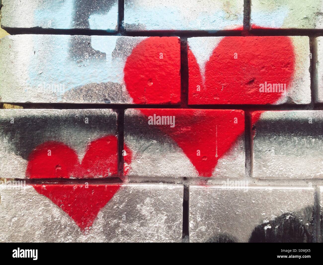 Heart graffiti on a brick wall Stock Photo