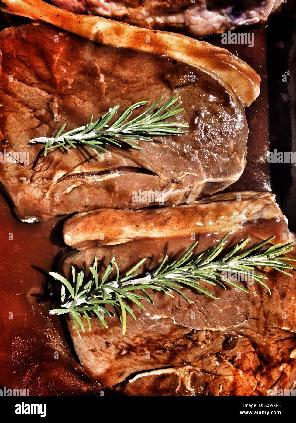 Steak in marinade with fresh rosemary Stock Photo Alamy