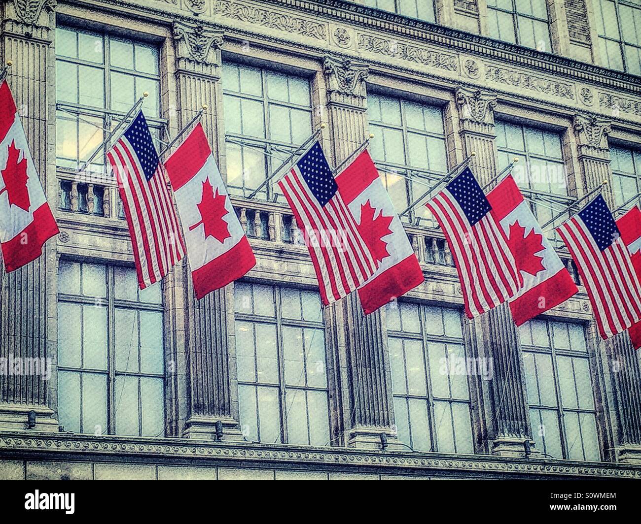 United States and Canadian flags outside of Saks fifth avenue in NYC - Smartphone Captured Stock Image