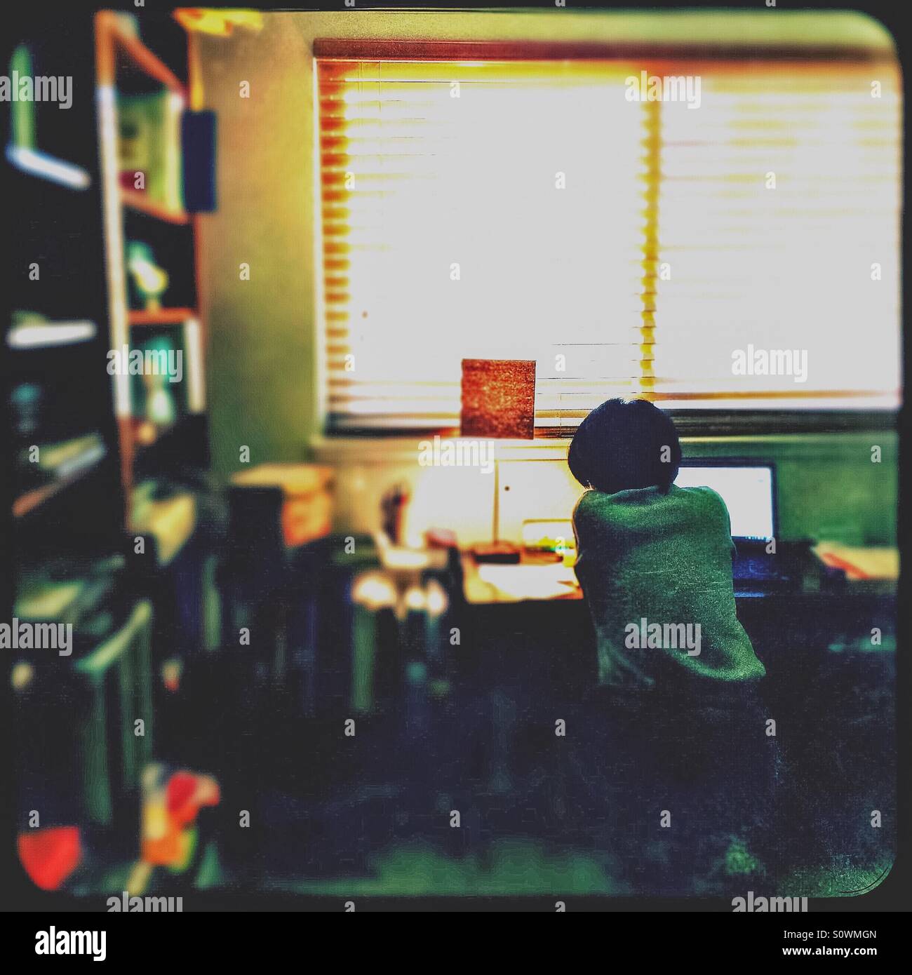 An Asian woman works from home in her office. - Smartphone Captured Stock Image