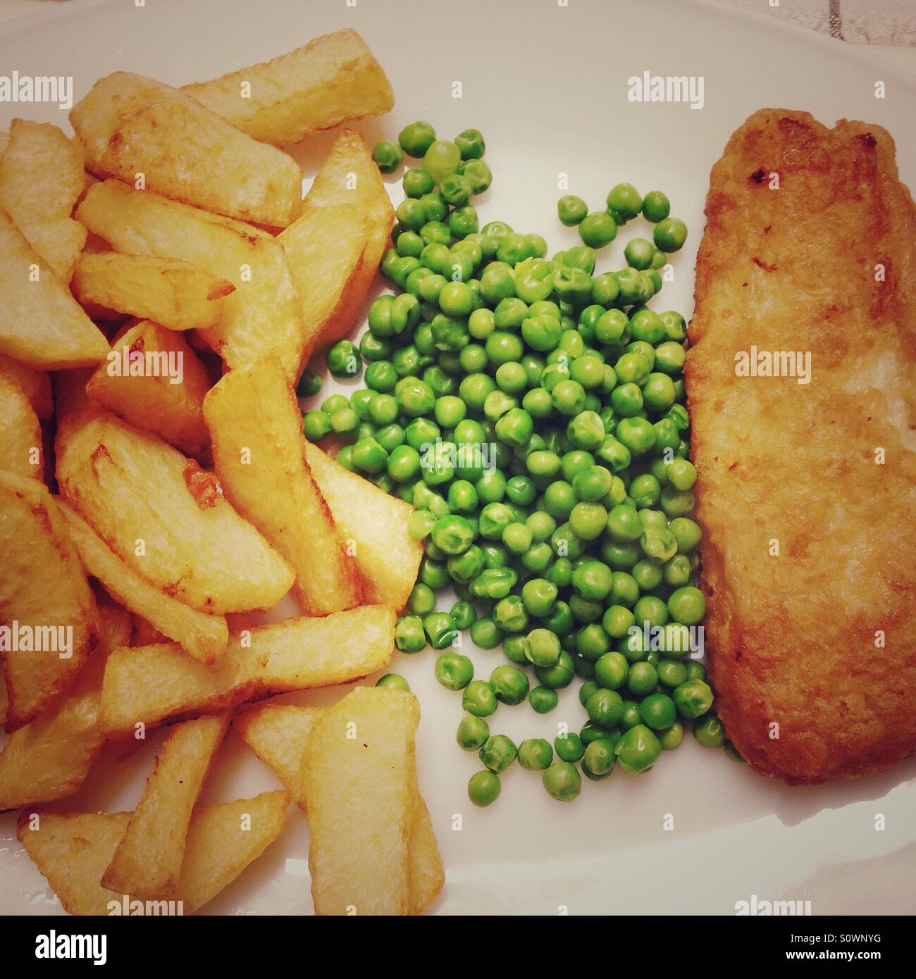 Chips, peas and fish. Stock Photo