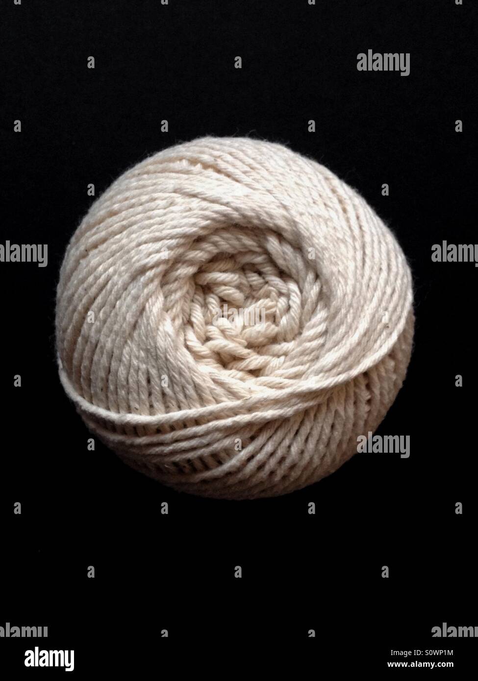 Ball of string on black background - Smartphone Captured Stock Image