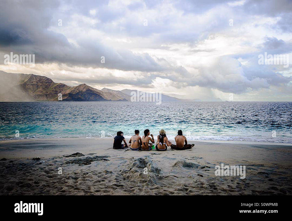 Taking time to relax at the beach with friends Stock Photo