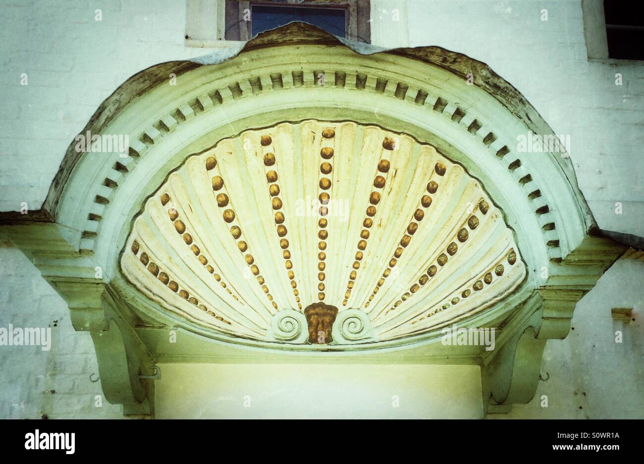 Pretty Georgian door canopy shaped like a clam shell. - Smartphone Captured Stock Image
