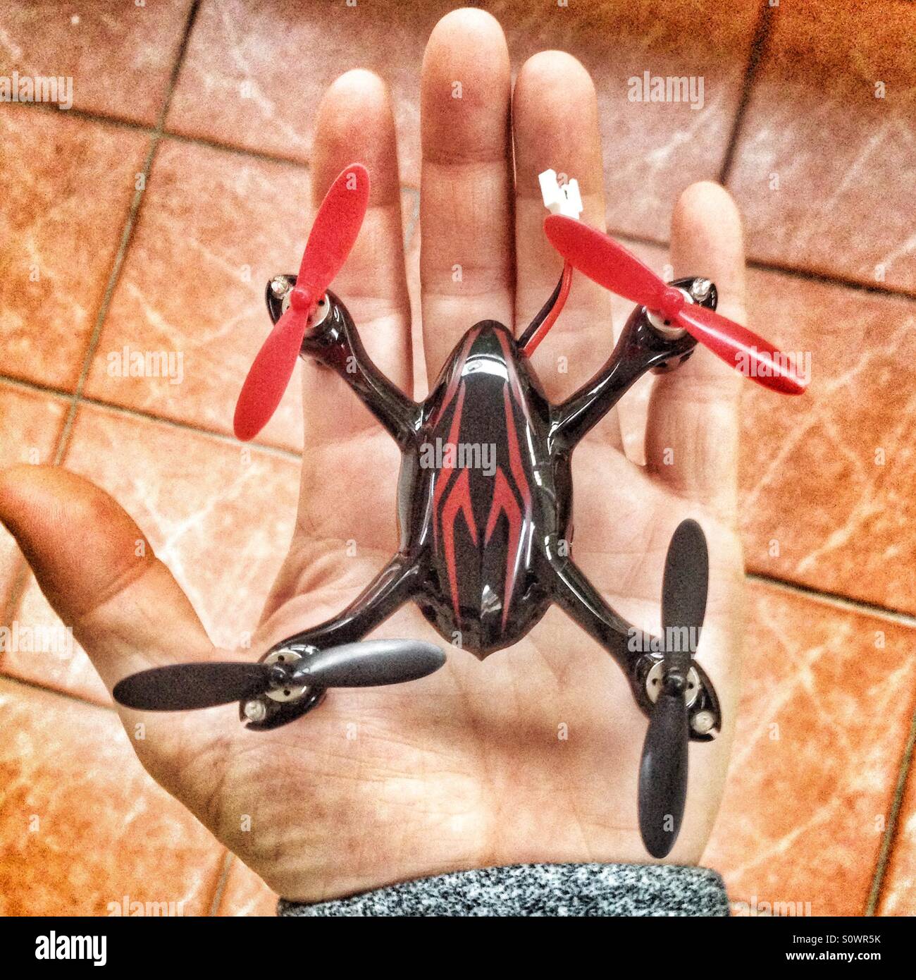 Tiny drone in a hand - Smartphone Captured Stock Image