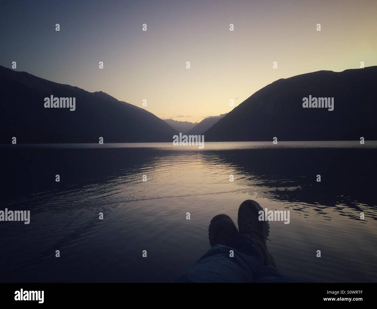 Feet and lake and mountains, Nelson Lakes National Park, Lake Rotoiti, New Zealand Stock Photo