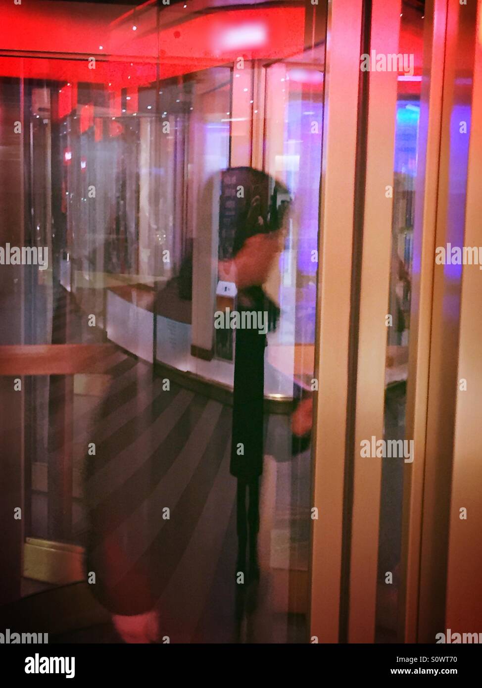 Man pushing through a revolving door NYC - Smartphone Captured Stock Image