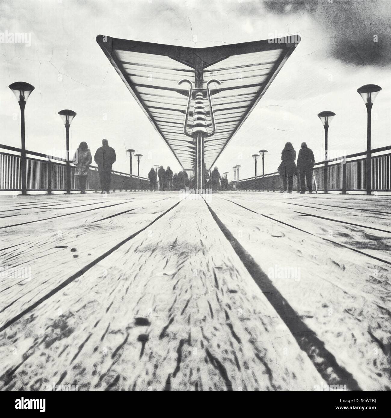 Figures walk on a pier - Smartphone Captured Stock Image