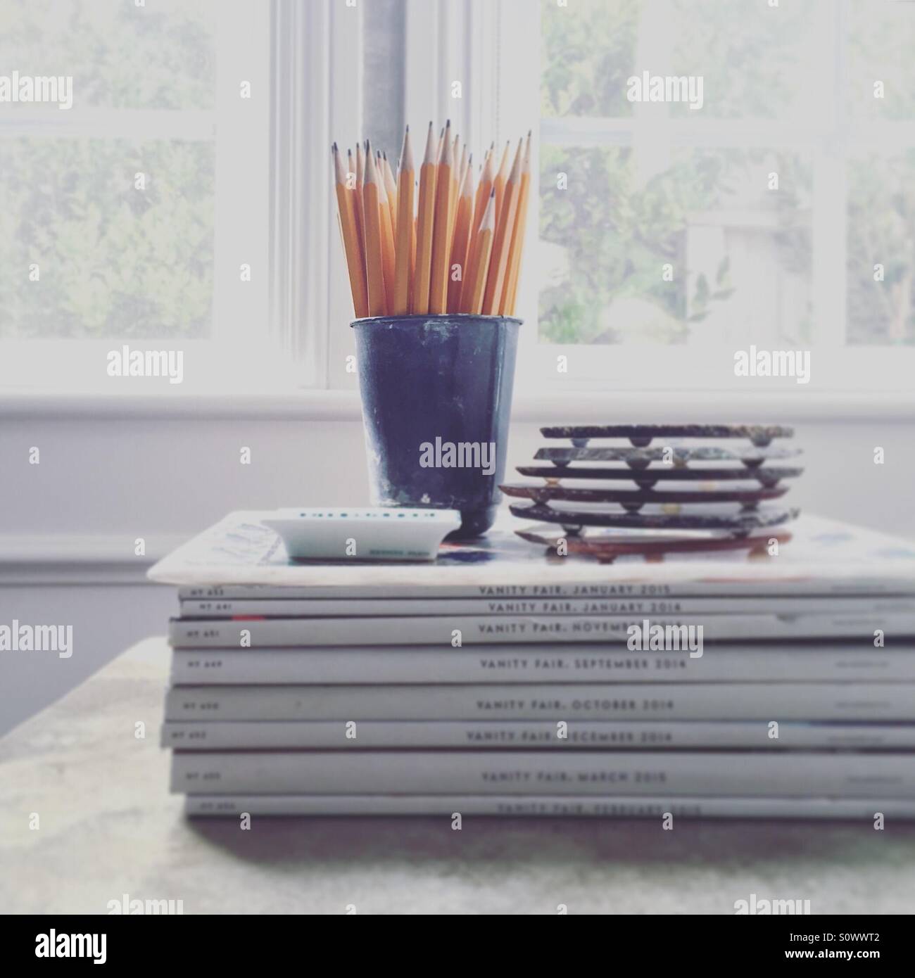 Pencils on stack of magazines - Smartphone Captured Stock Image